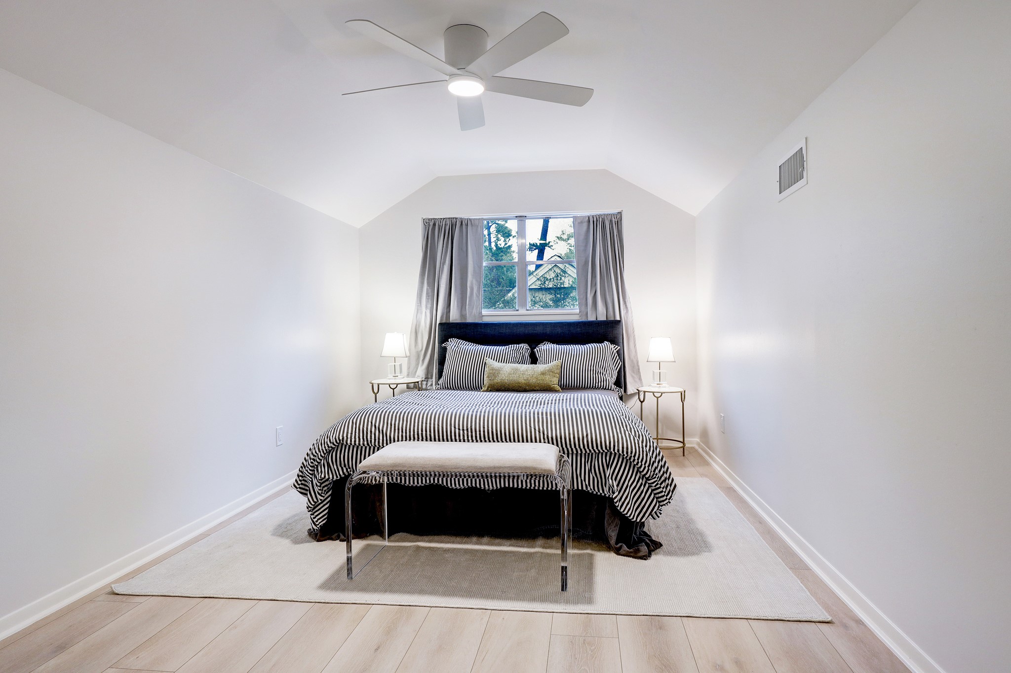 1810 Nocturne Lane Houston, TX 77043 - Photo 22 of 32 a bedroom with a bed and a ceiling fan