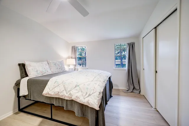 a bedroom with a bed and wooden floor