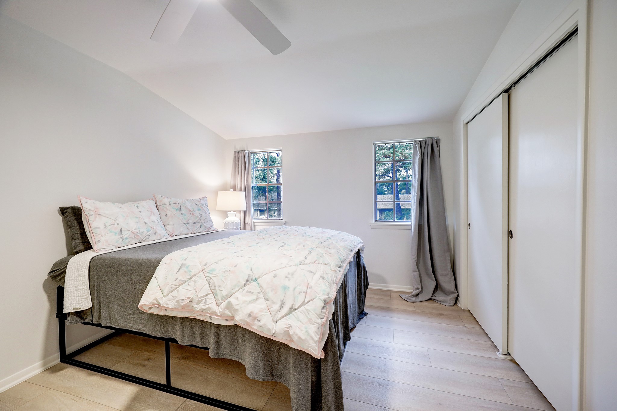 1810 Nocturne Lane Houston, TX 77043 - Photo 23 of 32 a bedroom with a bed and wooden floor