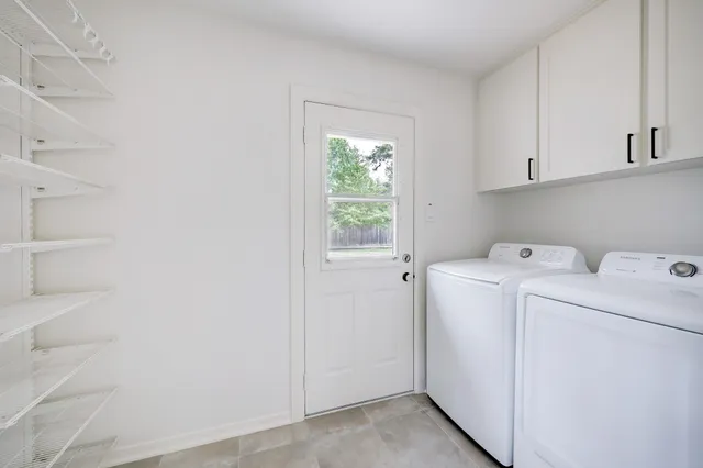 a view of storage and utility room with washer and dryer
