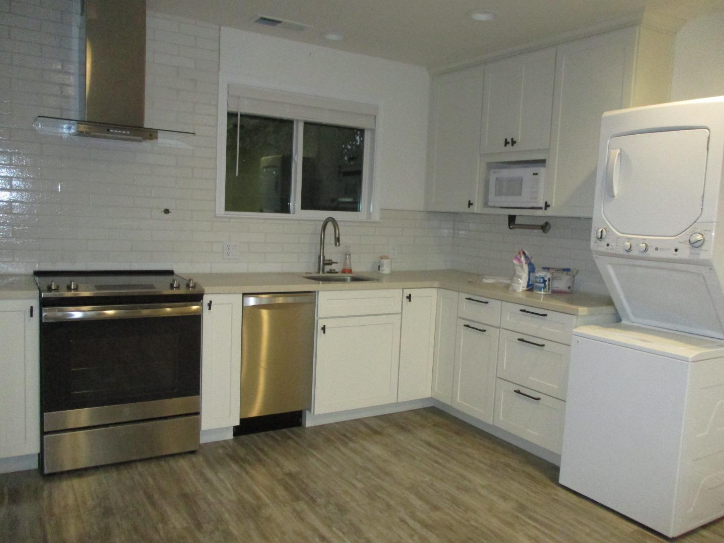 1160 3rd Street, Unit B Gilroy, CA 95020 - Photo 3 of 12 a kitchen with a sink stove and cabinets
