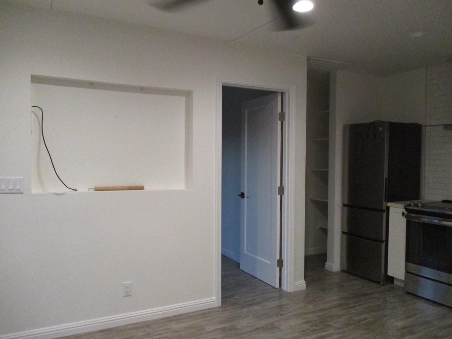 1160 3rd Street, Unit B Gilroy, CA 95020 - Photo 6 of 12 a view of a livingroom with wooden floor and a refrigerator
