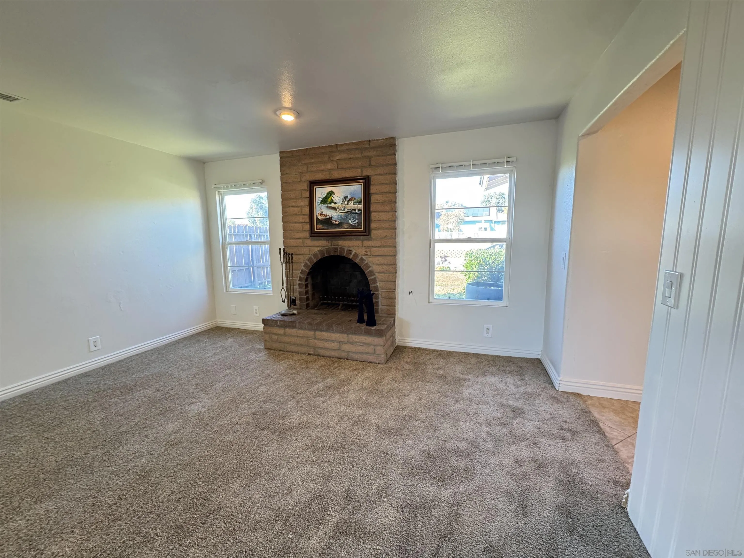 1531 View Pointe Avenue Escondido, CA 92027 - Photo 11 of 41 an empty room with windows and fireplace