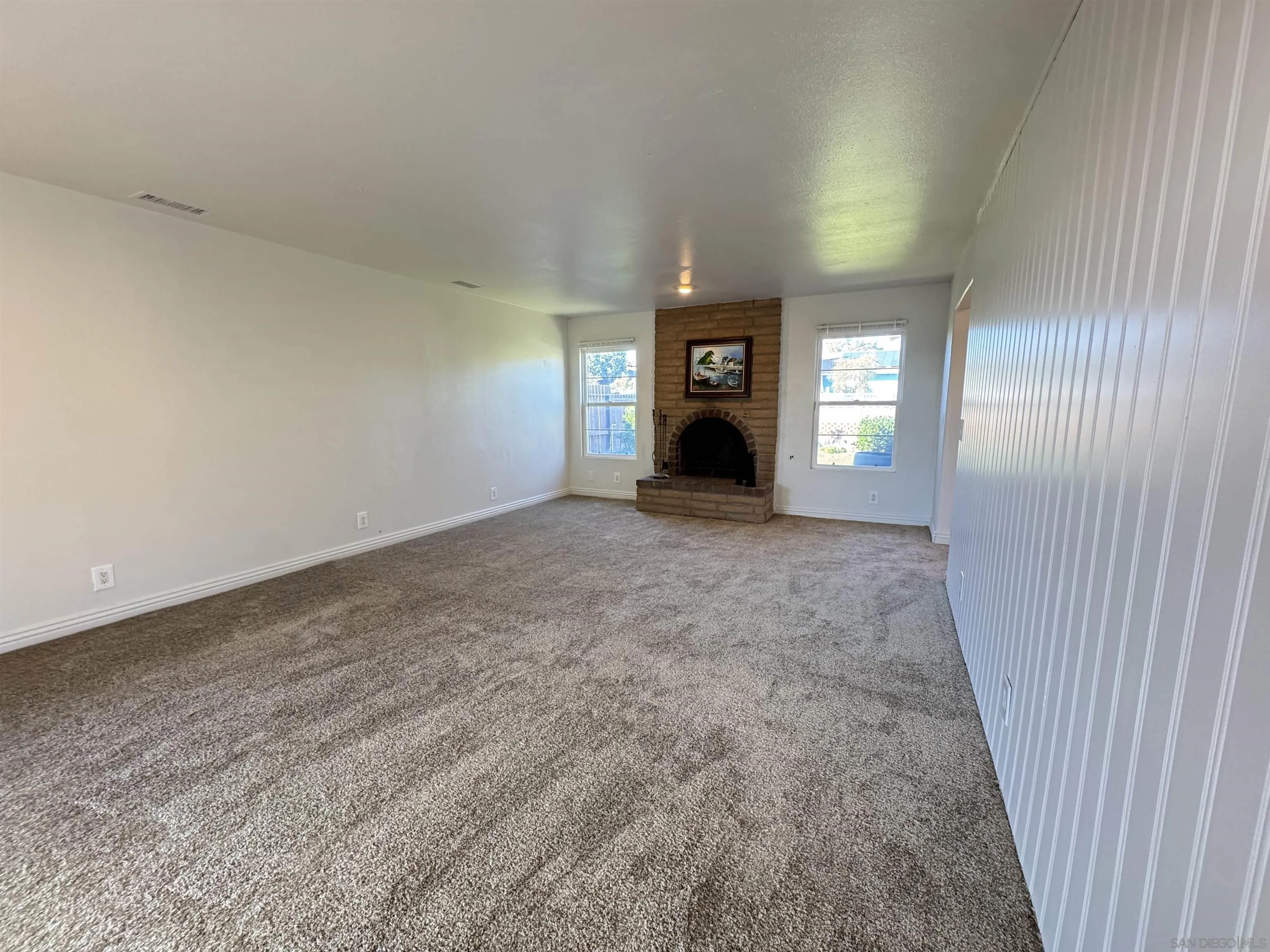1531 View Pointe Avenue Escondido, CA 92027 - Photo 12 of 41 an empty room with a fireplace and windows