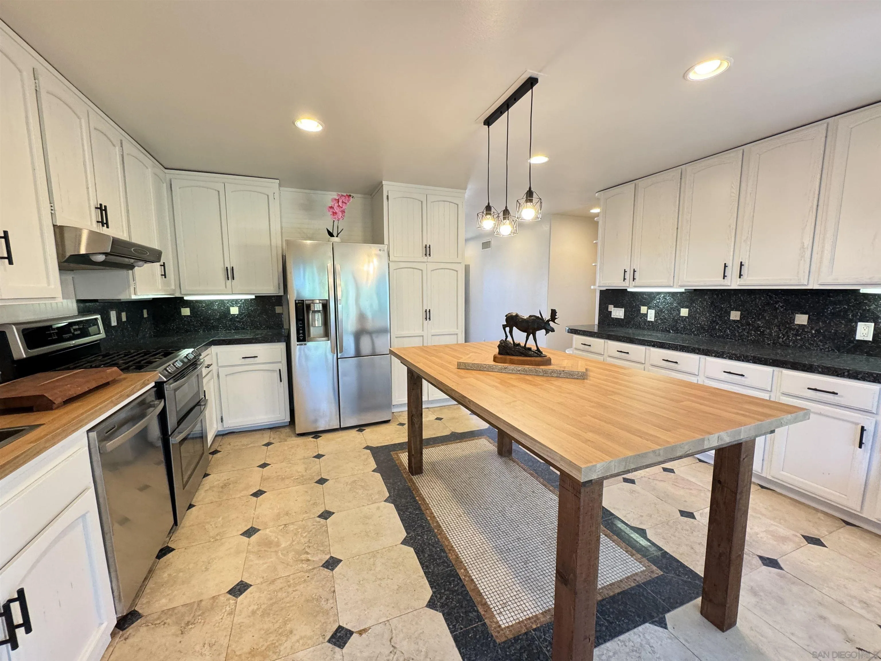 1531 View Pointe Avenue Escondido, CA 92027 - Photo 4 of 41 a kitchen with stainless steel appliances granite countertop a table chairs sink and cabinets