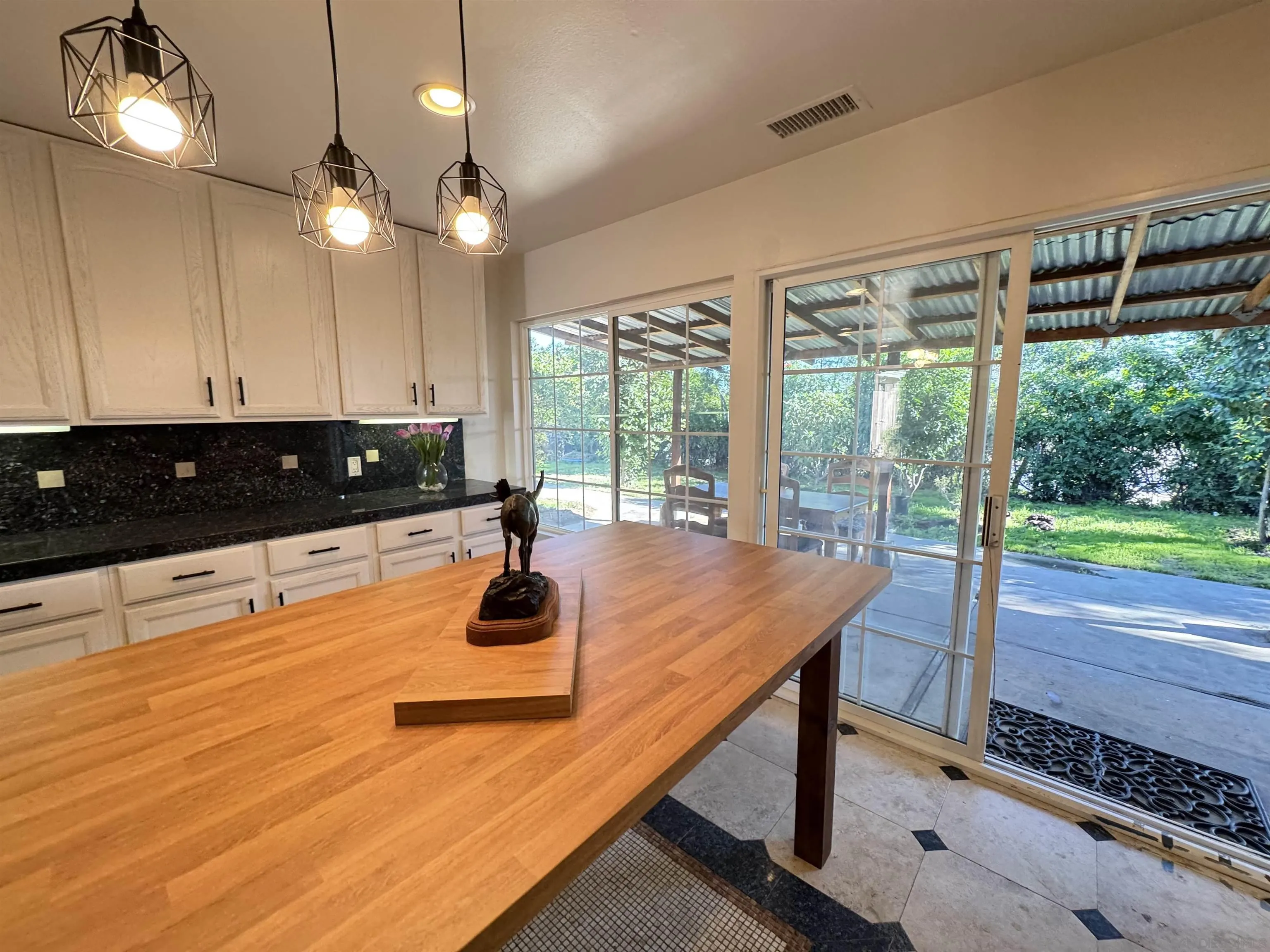 1531 View Pointe Avenue Escondido, CA 92027 - Photo 6 of 41 a kitchen with stainless steel appliances granite countertop a stove a refrigerator a sink and white cabinets with wooden floor