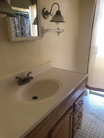 a kitchen with granite countertop a sink and a window