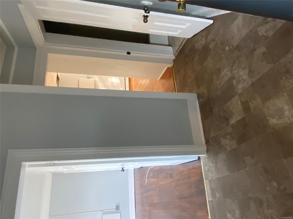 35 Main Street Walden, NY 12586 - Photo 5 of 10 Hall with dark wood-type flooring and a baseboard heating unit