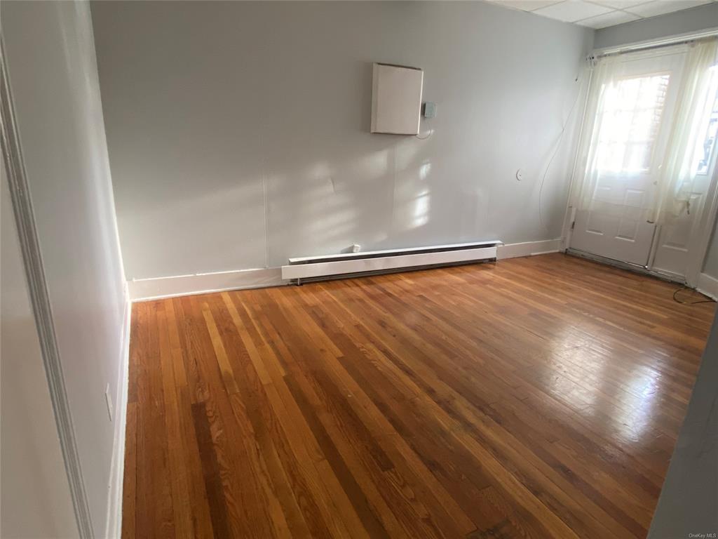 35 Main Street Walden, NY 12586 - Photo 7 of 10 Spare room with hardwood / wood-style floors, a drop ceiling, and baseboard heating