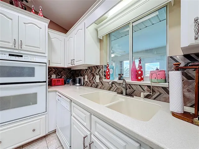 a bathroom with a granite countertop shower and a sink