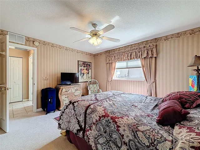 a bathroom with a tub a toilet and a shower