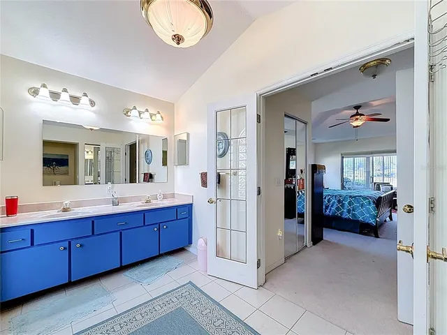 a front view of a house with a yard and potted plants