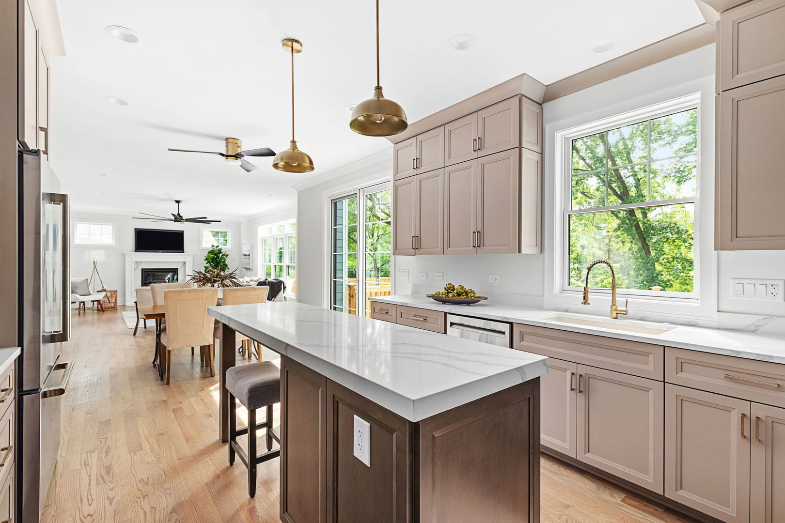 110 South Lorraine Road Wheaton, IL 60187 - Photo 16 of 40 a kitchen with a stove a sink a kitchen island with a dining table and chairs