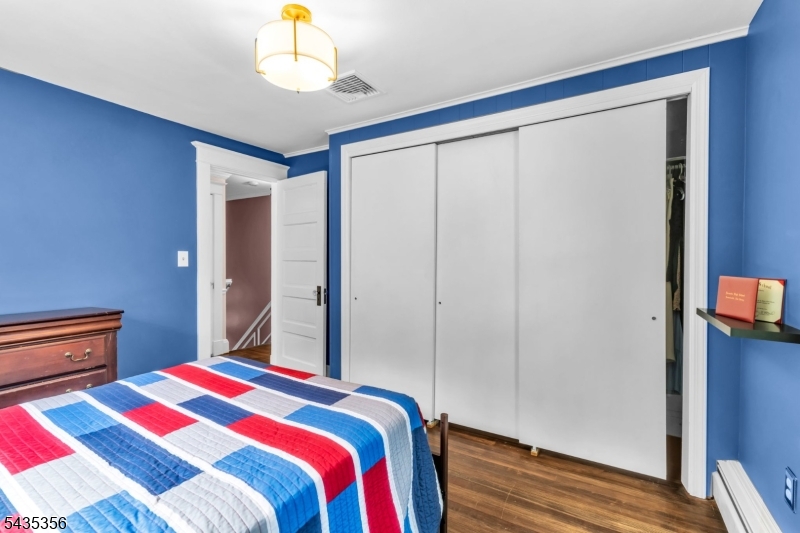 105 Somerville Road Bedminster, NJ 07921 - Photo 19 of 36 a bedroom with a bed and a chandelier