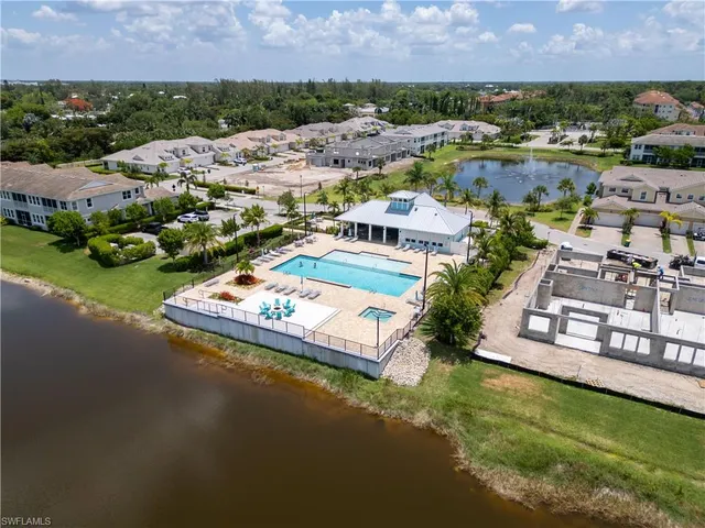 an aerial view of a house with a garden and lake view