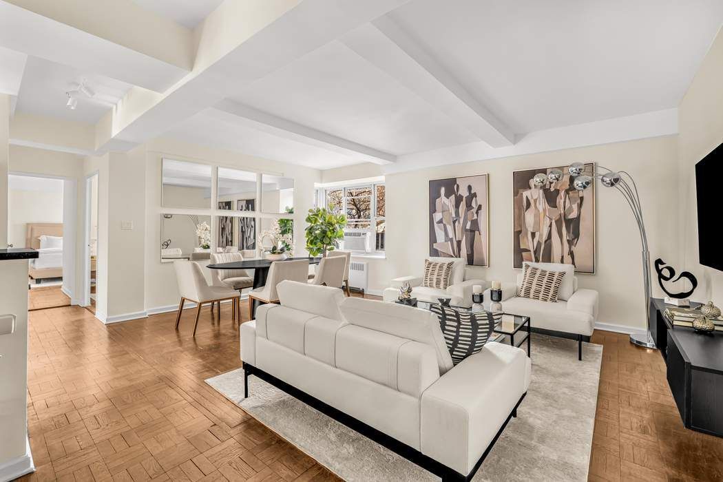 500 Grand Street, Unit C4H Manhattan, NY 10002 - Photo 2 of 11 a living room with furniture and a large window