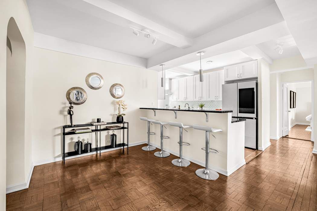500 Grand Street, Unit C4H Manhattan, NY 10002 - Photo 5 of 11 a large white kitchen with cabinets a sink and a stove