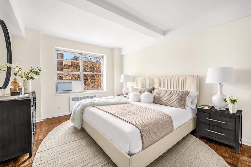 500 Grand Street, Unit C4H Manhattan, NY 10002 - Photo 6 of 11 a bedroom with a bed and a window