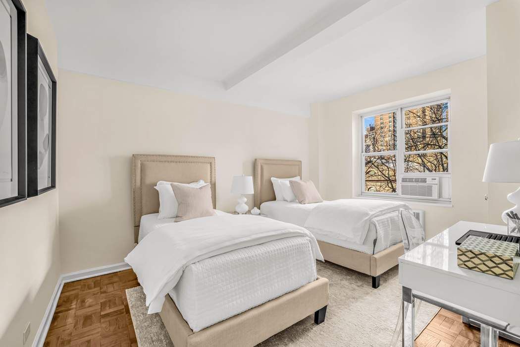 500 Grand Street, Unit C4H Manhattan, NY 10002 - Photo 8 of 11 a bedroom with two beds and a couch