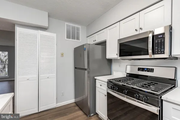 a kitchen with a sink cabinets and window