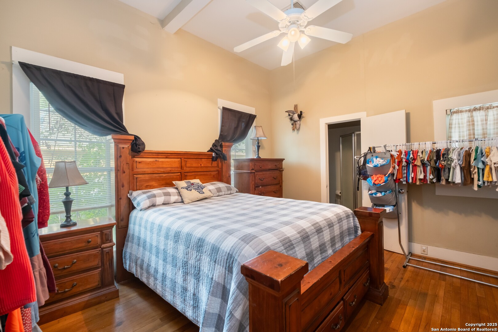 301 Jefferson Drive Devine, TX 78016 - Photo 14 of 29 a bedroom with a bed and a chandelier