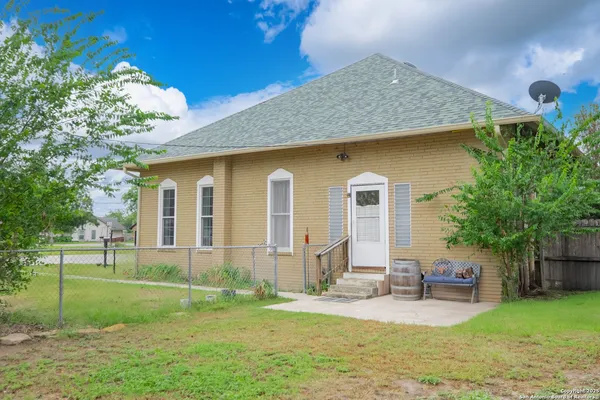 a front view of a house with a garden and yard