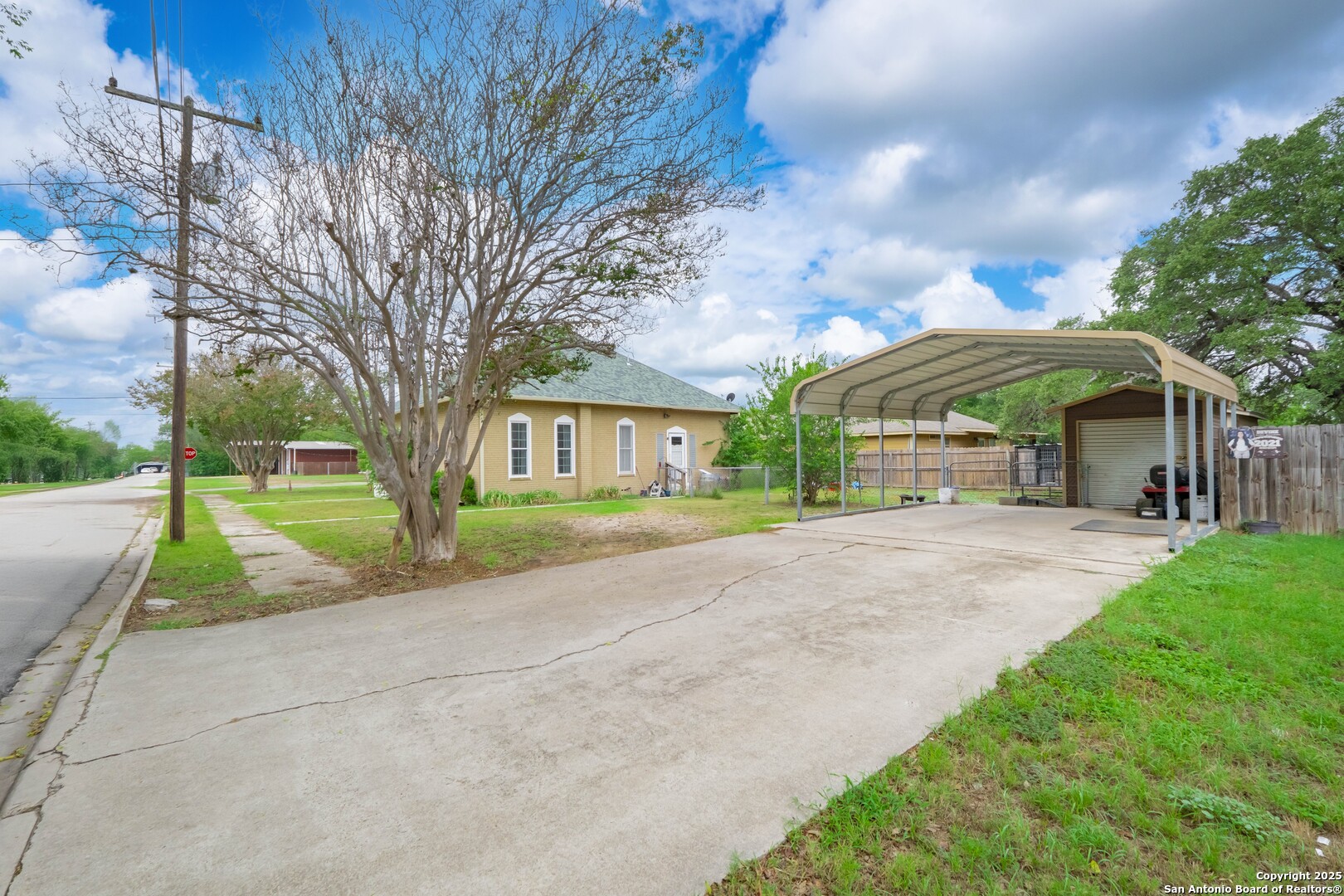 301 Jefferson Drive Devine, TX 78016 - Photo 25 of 29 a view of a house with a yard and large trees