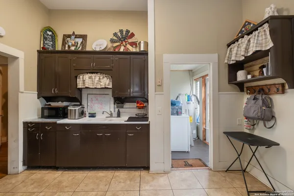 a kitchen with a cabinets and living room