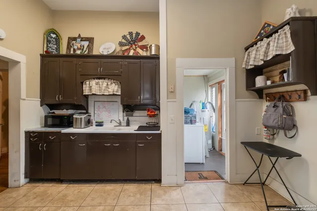 a kitchen with a cabinets and living room