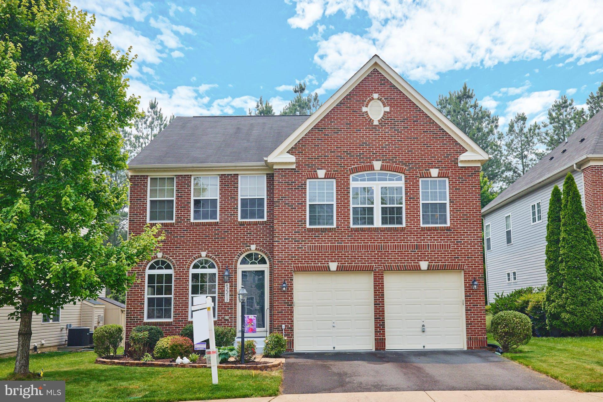 42213 St Huberts Place Chantilly, VA 20152 - Photo 1 of 63 front view of brick house with a yard