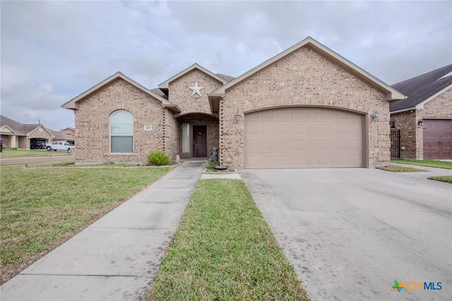 a front view of a house with a yard and garage