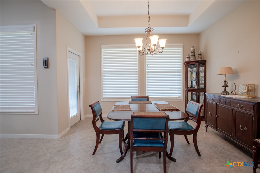 102 Luke Court Victoria, TX 77904 - Photo 15 of 33 a dining room with furniture a chandelier and wooden floor