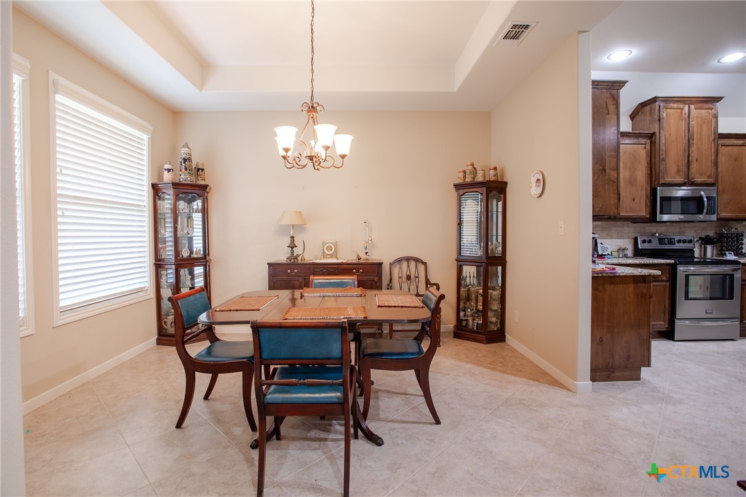 102 Luke Court Victoria, TX 77904 - Photo 16 of 33 a view of a dining room with furniture and chandelier