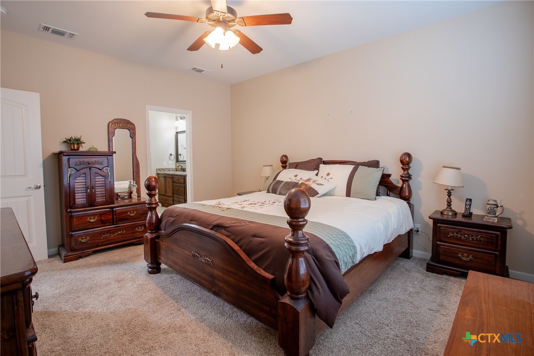 102 Luke Court Victoria, TX 77904 - Photo 17 of 33 a bedroom with a bed and a chandelier