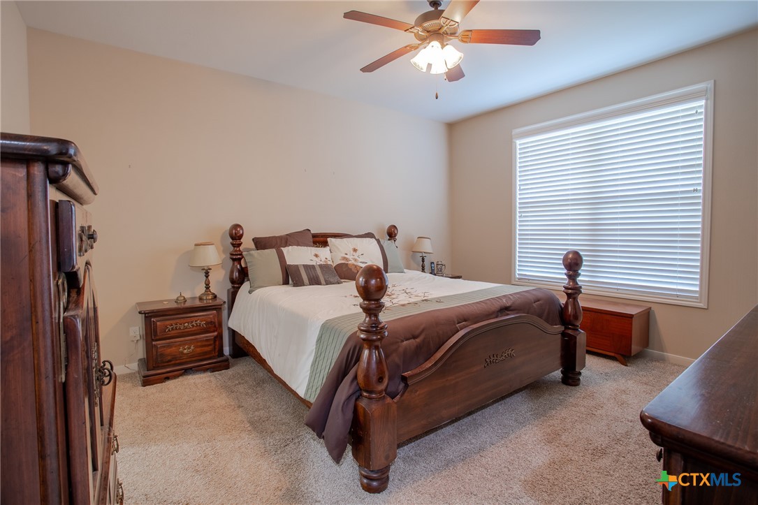 102 Luke Court Victoria, TX 77904 - Photo 18 of 33 a bedroom with a bed and a chandelier