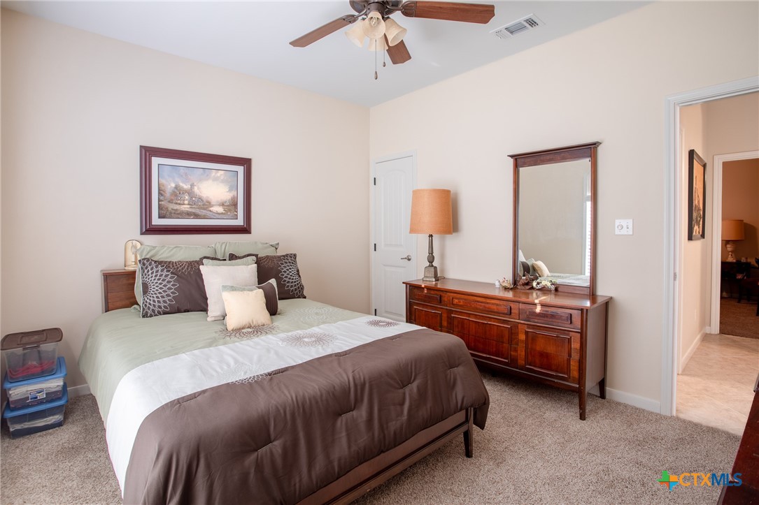 102 Luke Court Victoria, TX 77904 - Photo 23 of 33 a bedroom with bed and a chandelier