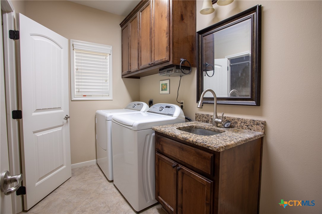 102 Luke Court Victoria, TX 77904 - Photo 27 of 33 a utility room with a sink washer and dryer
