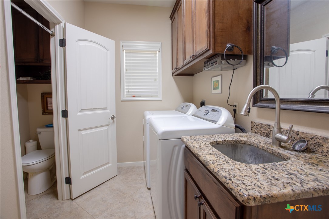 102 Luke Court Victoria, TX 77904 - Photo 28 of 33 a bathroom with a granite countertop sink a toilet and shower