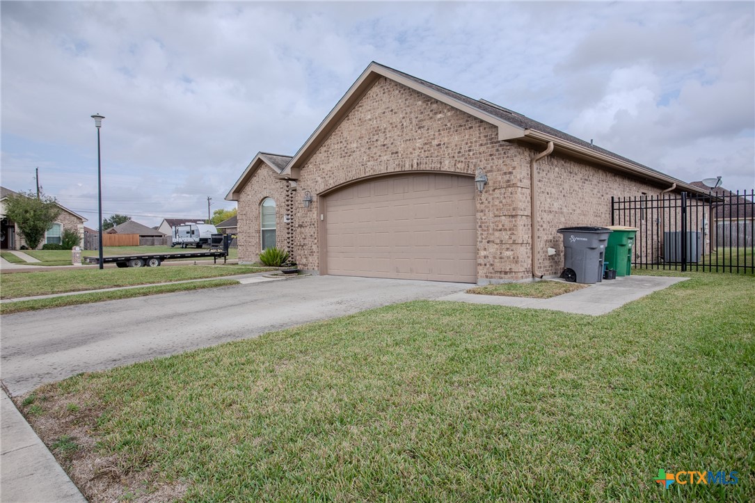 102 Luke Court Victoria, TX 77904 - Photo 3 of 33 a front view of a house with a yard and garage
