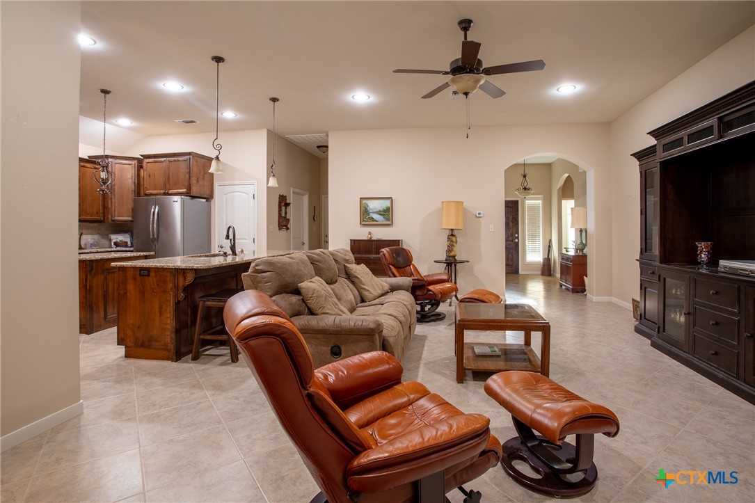 102 Luke Court Victoria, TX 77904 - Photo 8 of 33 a living room with furniture a flat screen tv and kitchen view