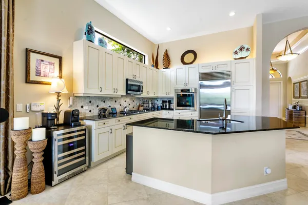 a kitchen with stainless steel appliances granite countertop a stove and a sink