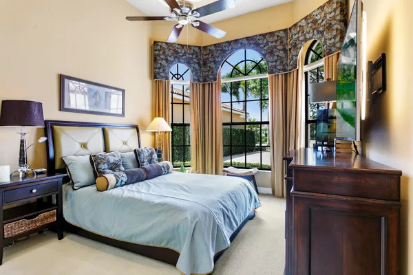 a bed room with a bed and a chandelier