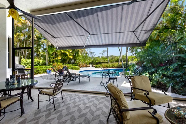 a view of an outdoor sitting area with furniture and garden view