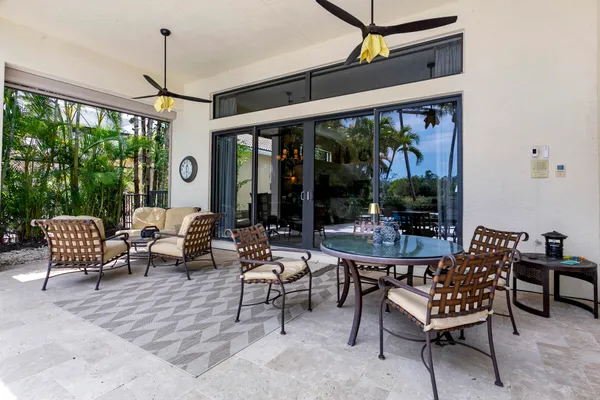 a living room with patio furniture and a potted plants