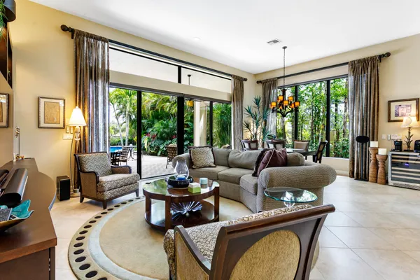 a living room with furniture and large windows