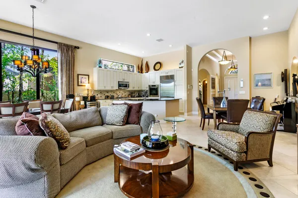 a living room with furniture fireplace and a large window