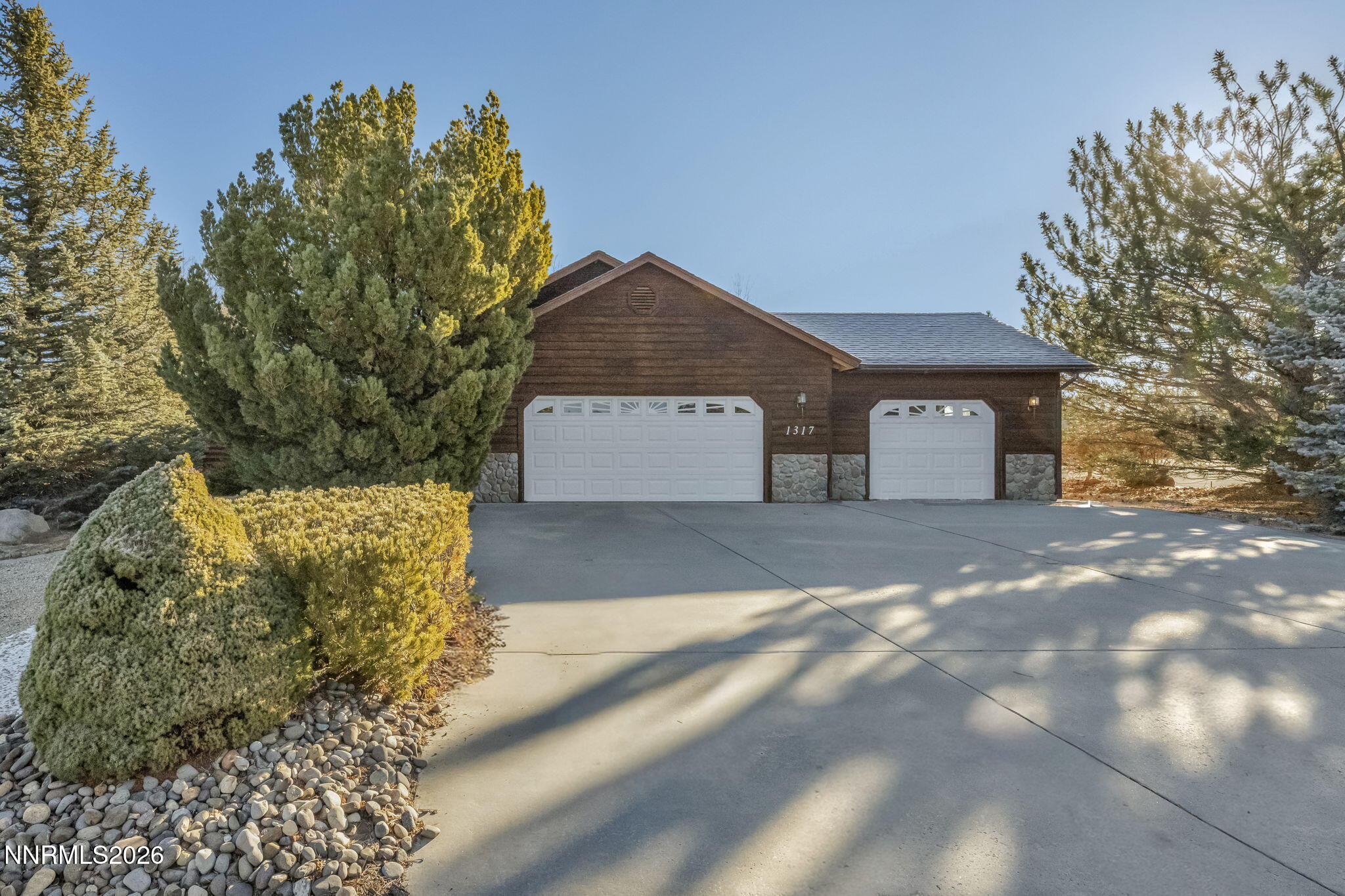 1317 Bridle Way Minden, NV 89423 - Photo 1 of 57 a front view of a house with a yard and garage