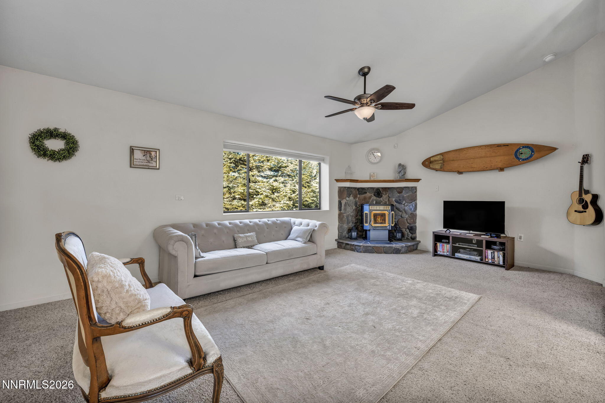 1317 Bridle Way Minden, NV 89423 - Photo 22 of 57 a living room with furniture a fireplace and a flat screen tv