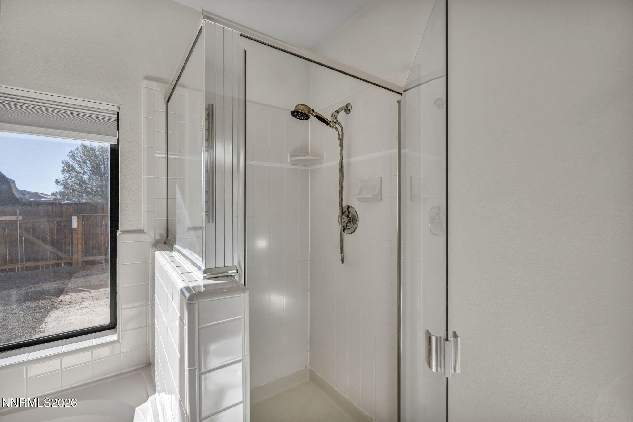 1317 Bridle Way Minden, NV 89423 - Photo 45 of 57 a bathroom with a glass shower door and a mirror