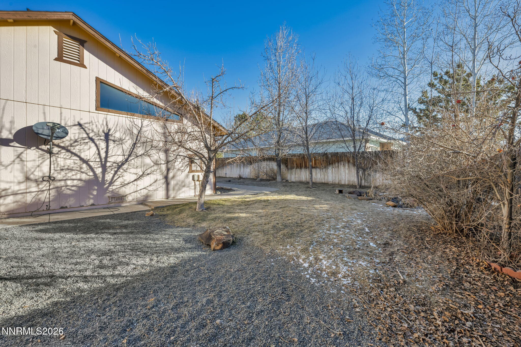 1317 Bridle Way Minden, NV 89423 - Photo 50 of 57 a backyard of a house with large trees and wooden fence